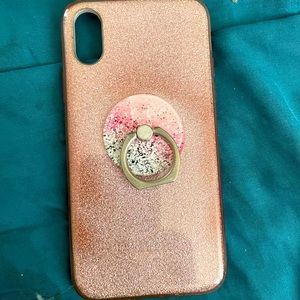 Pink glitter iPhone XS phone case attached is a pink and white pop socket